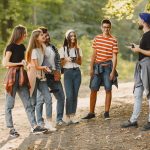 adventure-travel-tourism-hike-people-concept-group-smiling-friends-forest