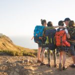 rear-view-happy-hiking-family-embracing